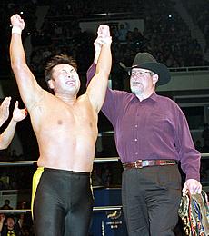 Hansen presents Kawada with title belts from Sponichi